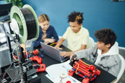 Group of focused children using laptop